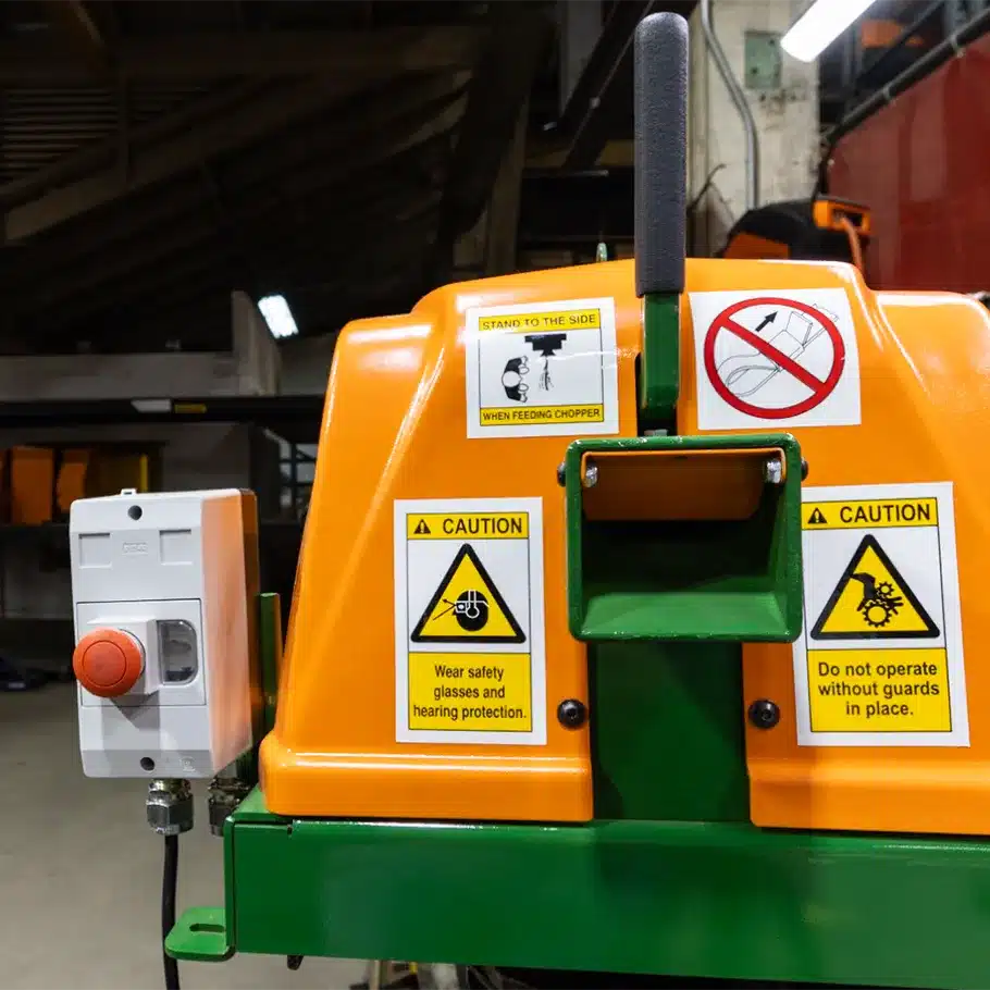 Front view of a SWEED Model 300 scrap chopper for plastic strapping and steel banding processing with safety notifications